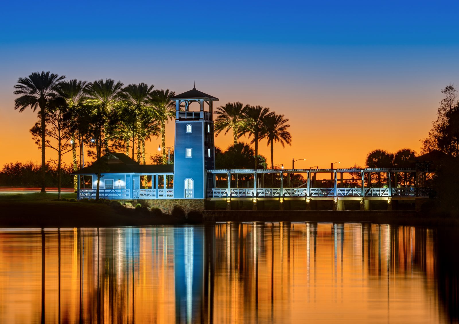 Lake Tradition at twilight in Port St. Lucie, with palm trees reflected in the water.