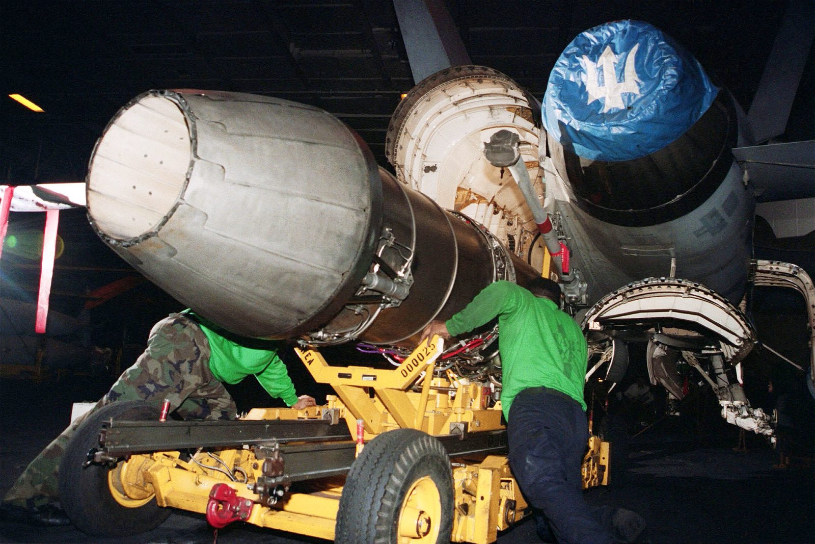Technicians working on a jet engine. Illustrative, not a GA Telesis facility.