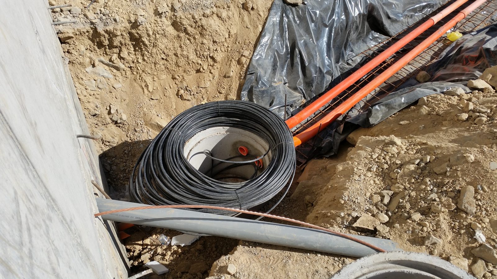 Fiber optic cable being laid in a trench. Illustrative, not a Wire 3 project.